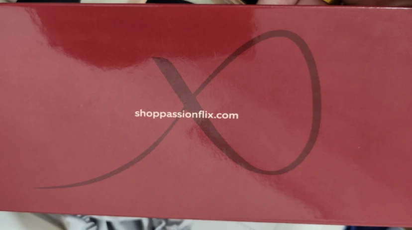 Nahaufnahme der individuell gestalteten Seiden-Augenmaskenbox von PASSIONFLIX mit Markenlogo und offizieller Website.