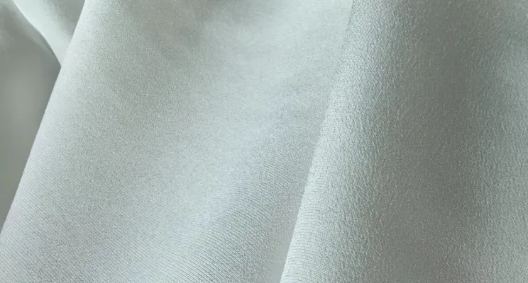 White silk CDC fabric close-up with subtle crepe surface