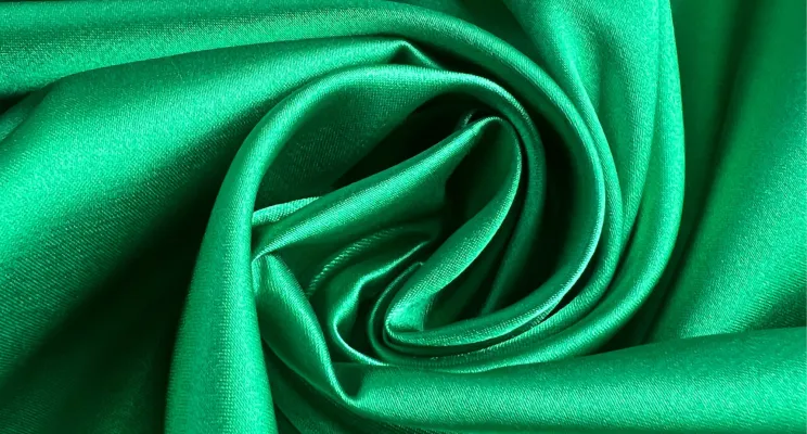 Green silk charmeuse fabric swatch with rich emerald tone