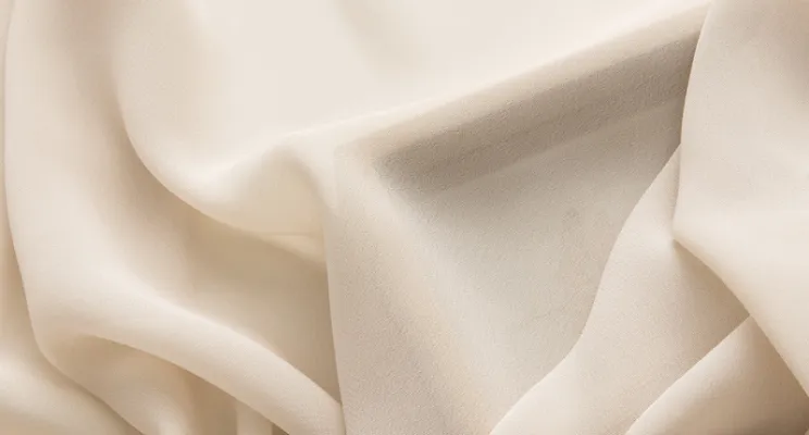 Ivory silk chiffon fabric swatch in soft cream tone