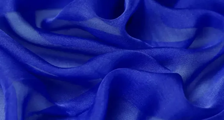 Blue silk chiffon fabric detail with flowing drape