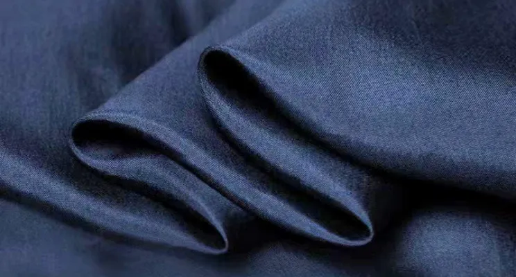 Navy silk habotai fabric close-up with even dye coverage